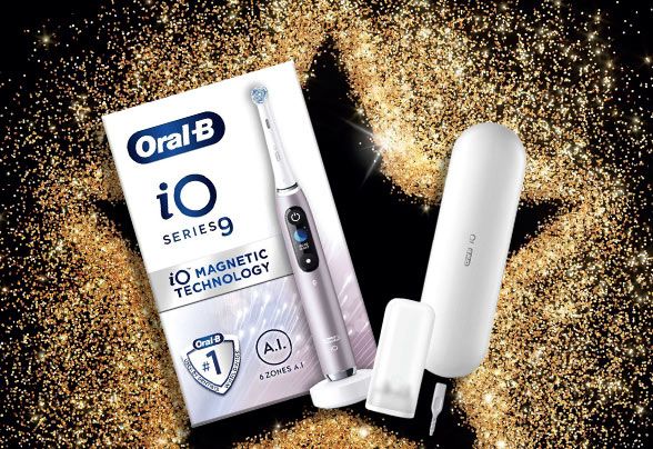 Oral-B product surrounded by gold glitter on a black background