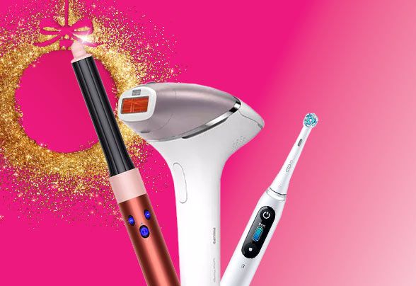 Braun, Philips and Oral-B products beside a gold glittery bauble on a bright pink background